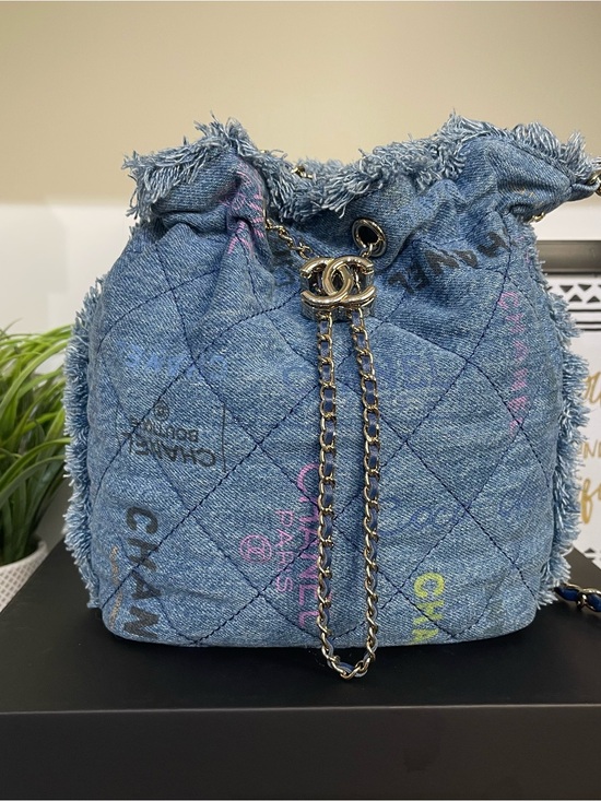 CHANEL Handbags - CHANEL Quilted Denim Drawstring Bucket Bag - Blue with Multicolor Accents
